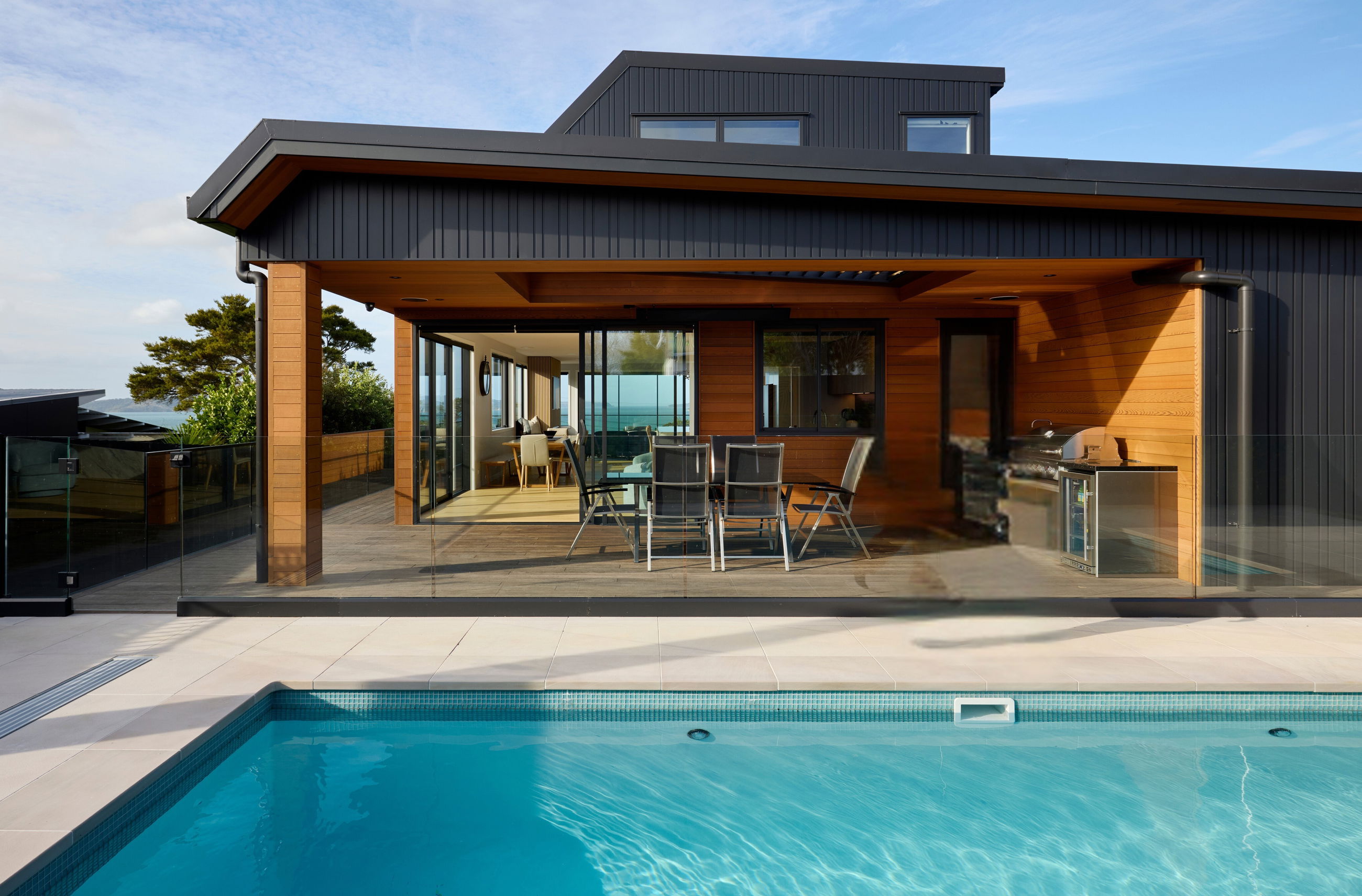 FMI Building Innovation glass pool fencing in front of a striking coastal home